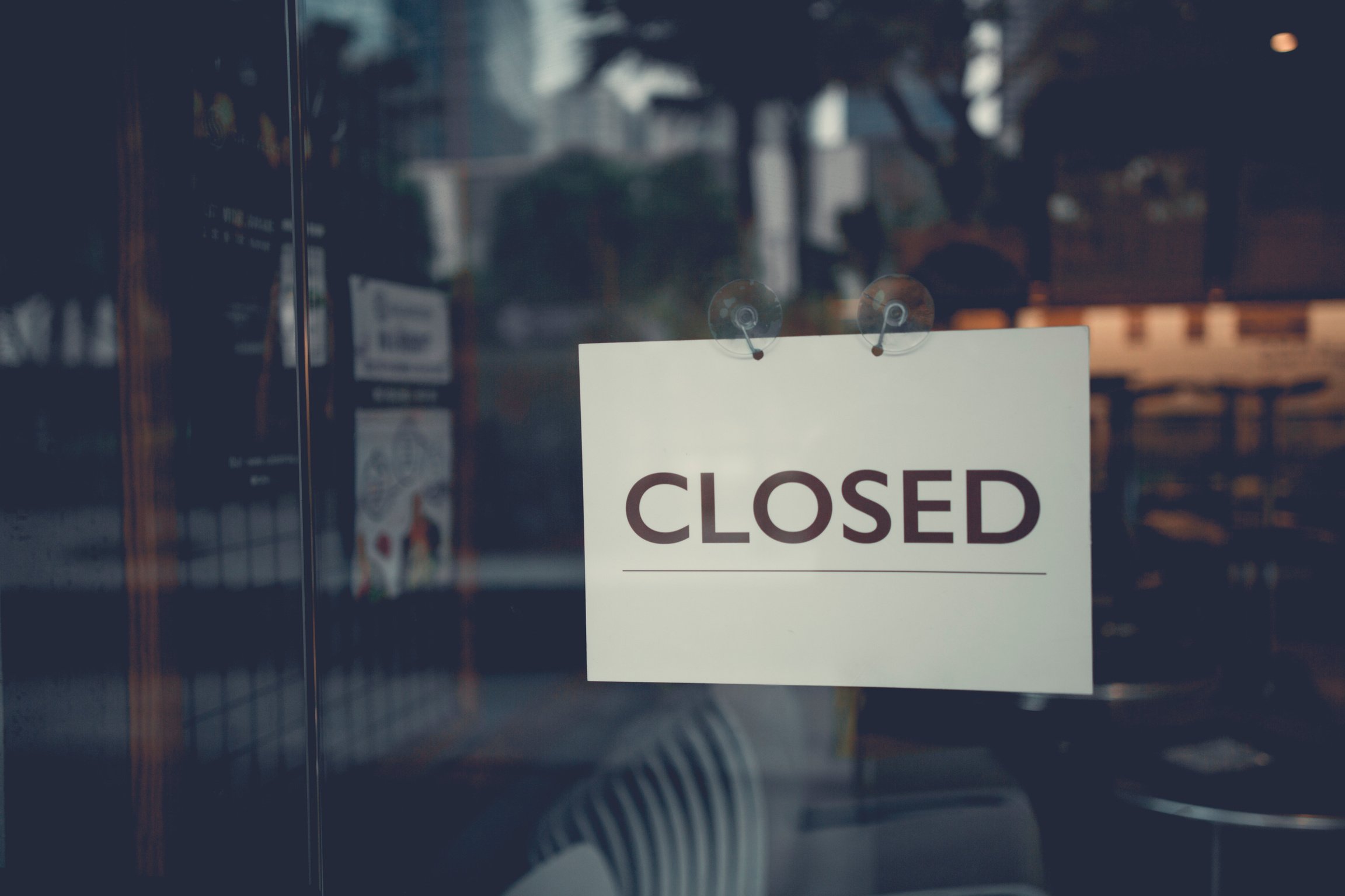 Closed sign on a glass door